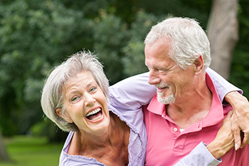 Elderly couple smiling and laughing with each other